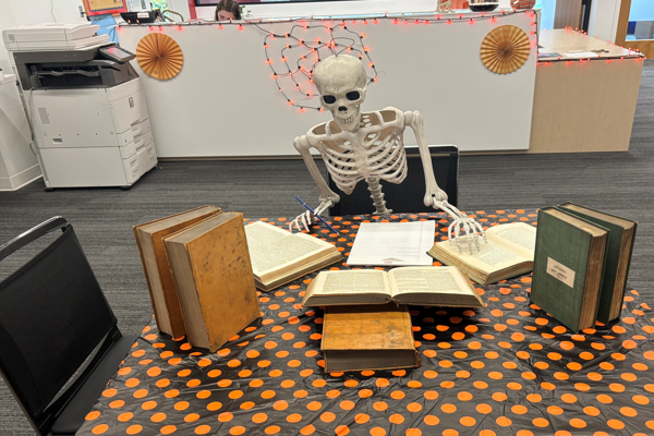 Skeleton doing legal research in the library