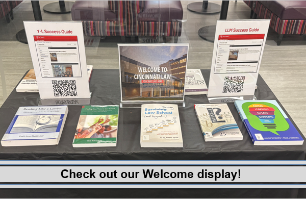 Welcome display showing law school study aids and QR codes for guides